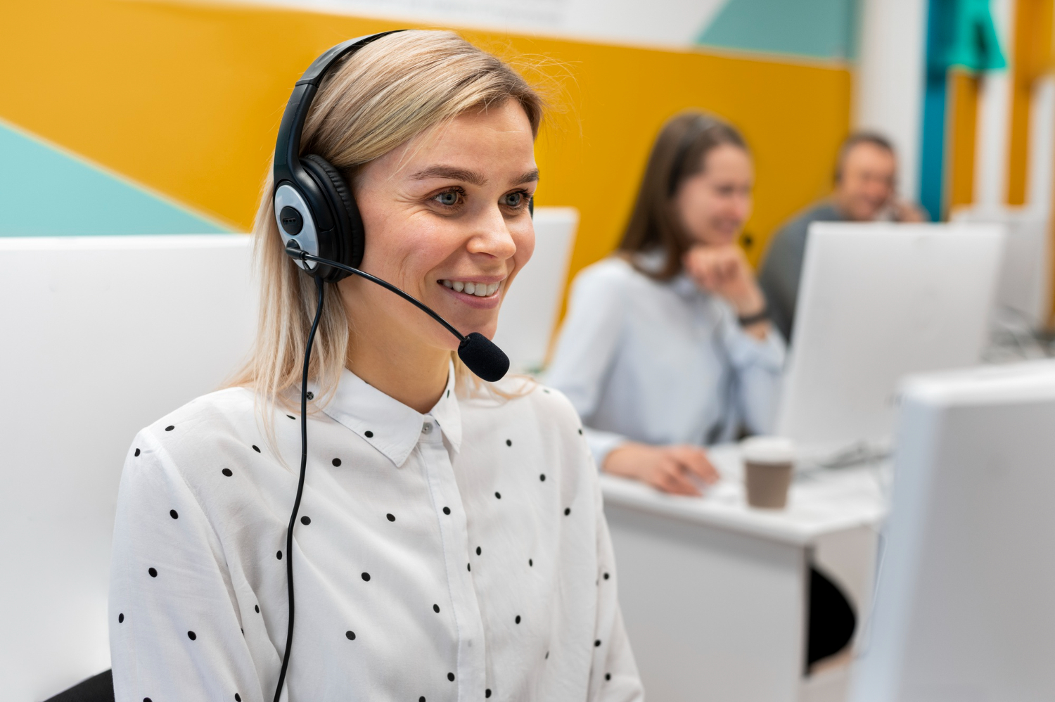 blond-woman-working-call-center-with-headphones-computer